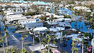 Water floods a damaged trailer park in Fort Myers