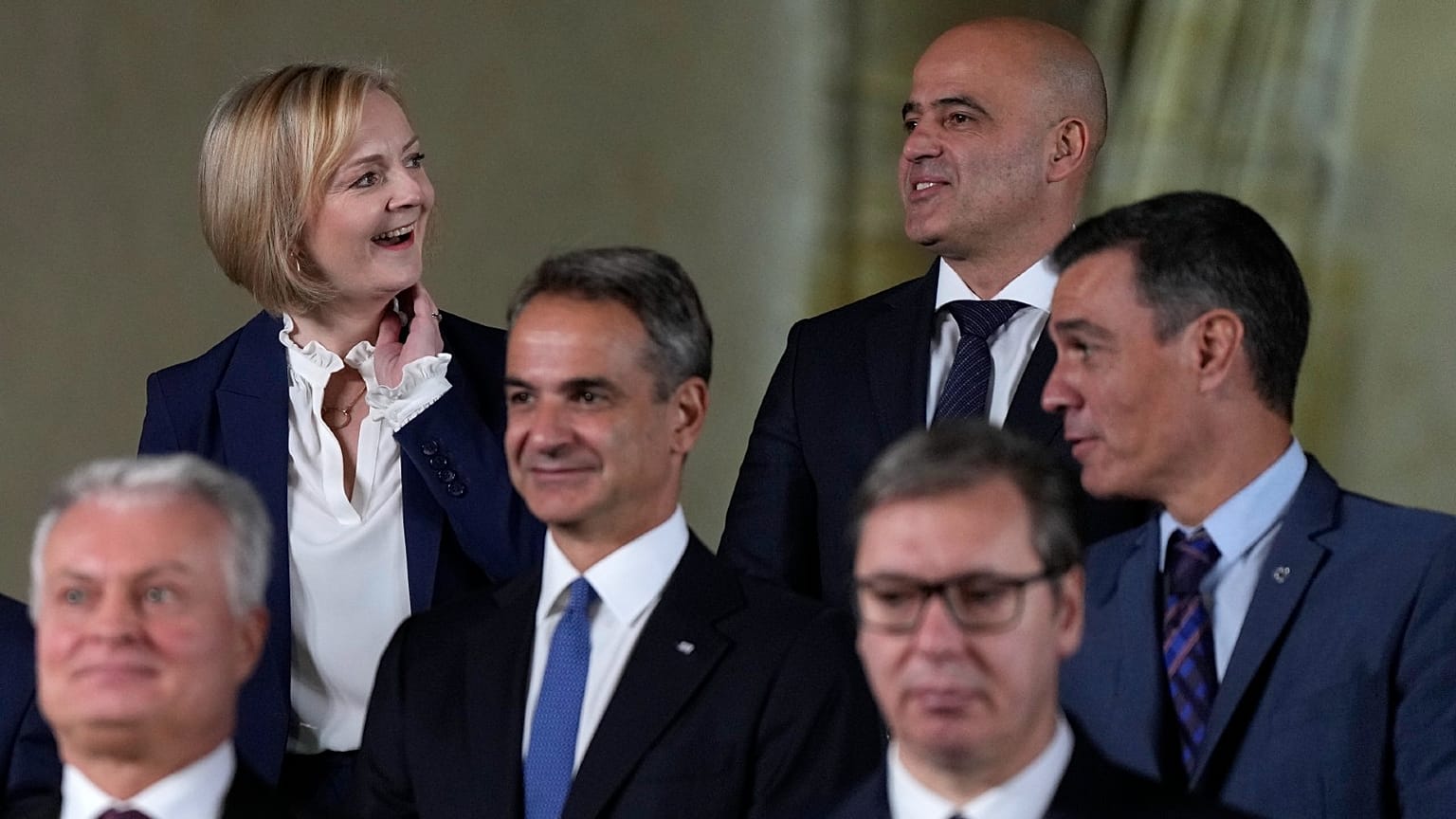 British PM Liz Truss, top left, speaks with North Macedonia's PM Dimitar Kovacevski, top right, at a group photo during a meeting of the European Political Community