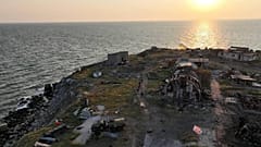 Ukrainian service members walk next to destroyed buildings, as Russia's attack on Ukraine continues, on Snake (Zmiinyi) Island, in Odesa region.