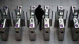 Un usager du métro passe le portique à Gare du Nord
