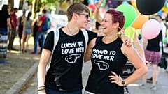 Two women smile at each other as they take part in the Gay Pride Parade in Ljubljana, Slovenia, on June 13, 2015