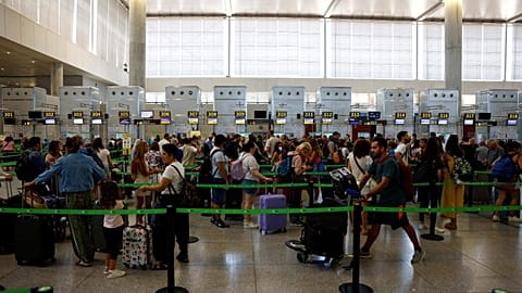 Vueling passengers queue at check-in desks at Malaga-Costa del Sol Airport in Malaga, Spain.