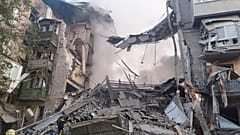 In this photo provided by the Ukrainian Emergency Service, rescuers work at the scene of a building damaged by shelling in Zaporizhzhia, Ukraine, Thursday, Oct. 6, 2022. 