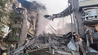 In this photo provided by the Ukrainian Emergency Service, rescuers work at the scene of a building damaged by shelling in Zaporizhzhia, Ukraine, Thursday, Oct. 6, 2022. 