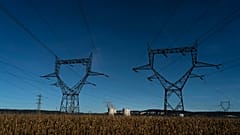 Electricity poles are pictured in a field near the Bugey nuclear plant of Saint-Vulbas, central France, Monday, Sept. 12, 2022.