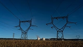 Electricity poles are pictured in a field near the Bugey nuclear plant of Saint-Vulbas, central France, Monday, Sept. 12, 2022.
