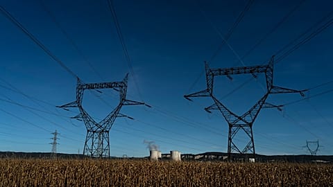 Electricity poles are pictured in a field near the Bugey nuclear plant of Saint-Vulbas, central France, Monday, Sept. 12, 2022.