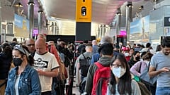 Travellers queue at security at Heathrow Airport in London in June.