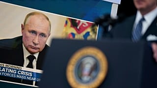 President Joe Biden speaks about gas prices in the South Court Auditorium on the White House campus as photo of Russian President Vladimir Putin is on a screen behind him