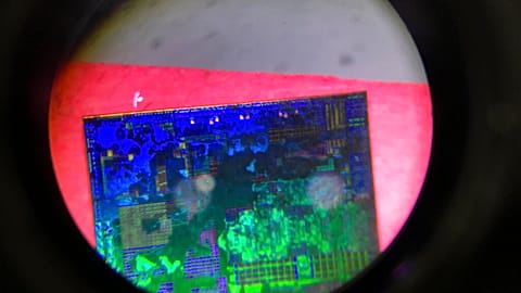A Chinese microchip is seen through a microscope set up at the booth for Tsinghua Unigroup project at the China Beijing International High-tech Expo in Beijing on May 17, 2018
