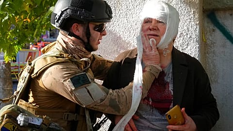 An injured woman receives medical treatment at the scene of Russian shelling.