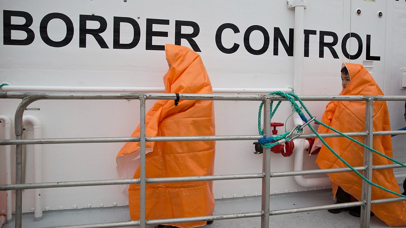 Two children disembark with other migrants and refugees from a Norwegian Frontex patrol vessel on Greek island of Lesbos, March 22, 2016. 