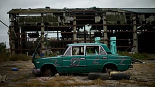 An abandoned car lies on the ground in a heavily damaged grain factory where Russians forces gathered destroyed vehicles at the recaptured town of Lyman, Ukraine