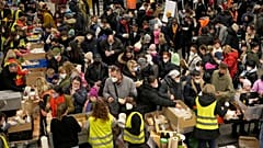 Ukrainian refugees queue for food in the welcome area after their arrival at the main train station in Berlin, Germany, March 8, 2022.