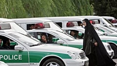 شرطية إيرانية للأخلاق بين سيارات شرطة الأخلاق في طهران.