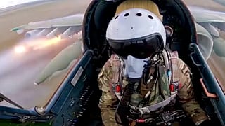 A Russian air force pilot is seen in the cockpit of his Su-25 as it flies on a mission in Ukraine.