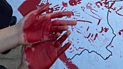 Students show their red hands during protests at the Art University in Isfahan, October 2022