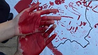 Students show their red hands during protests at the Art University in Isfahan, October 2022