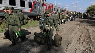 Russian recruits walk to take a train at a railway station in Prudboi, Volgograd region of Russia, 29 September 2022