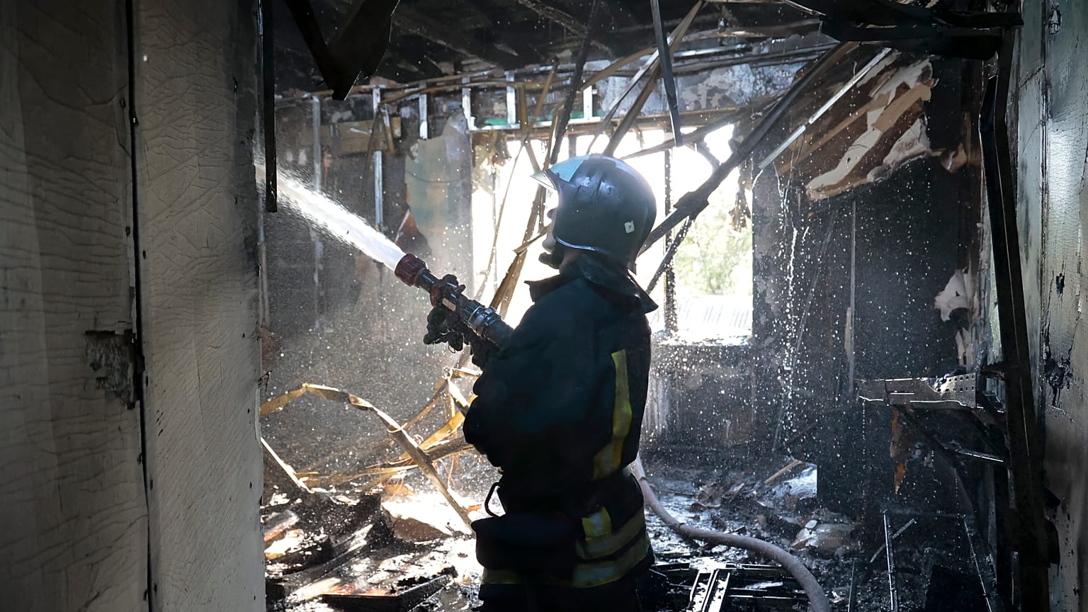 A firefighter works at the site of the burning after shelling in Donetsk.