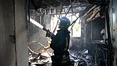 A firefighter works at the site of the burning after shelling in Donetsk.