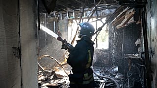 A firefighter works at the site of the burning after shelling in Donetsk.