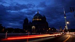 The Television Tower glows at dusk next to the Protestant Berlin Cathedral with a reduced lighting to save energy due to Russia's invasion of Ukraine in Berlin