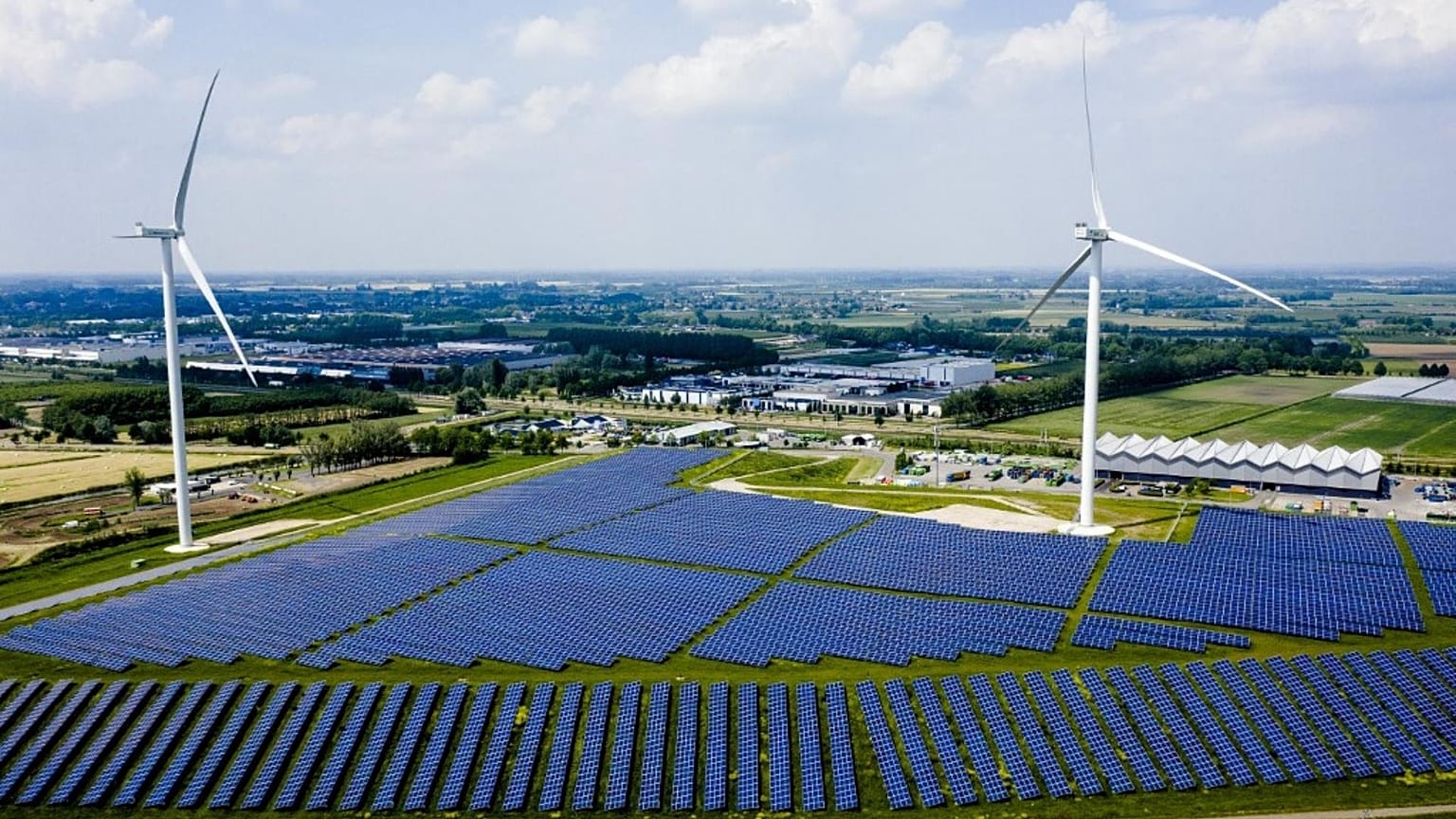 This aerial view shows the Avri solar park along the highway 'A15' in Geldermalsen. With 34,000 solar panels, the park is the largest in Gelderland, Netherlands. 