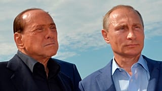 Russian President Vladimir Putin, right, and former Italian Prime Minister Silvio Berlusconi visit a memorial to the soldiers from Sardinia killed in the Crimean War, near Mou
