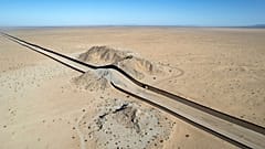 Aerial view of a hill on the dessert crossed by a section of the US - Mexico border wall near San Luis Rio Colorado, Mexico, on September 19, 2022. 