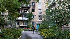 A man walks in front of a building that was damaged by a missile in Irpin, near Kyiv, Ukraine