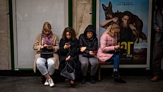 People sit in the Kyiv subway, using it as a bomb shelter, in Kyiv, Ukraine, on Wednesday, Oct. 19, 2022.