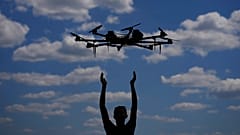 A person releases a drone. 