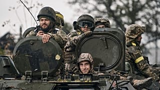 Ukrainian soldiers ride an APC in Donetsk region, 20 October 2022