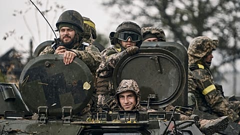 Ukrainian soldiers ride an APC in Donetsk region, 20 October 2022