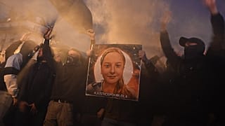 Protesters gesture around a portrait of "Lola" in Paris on Thursday evening.