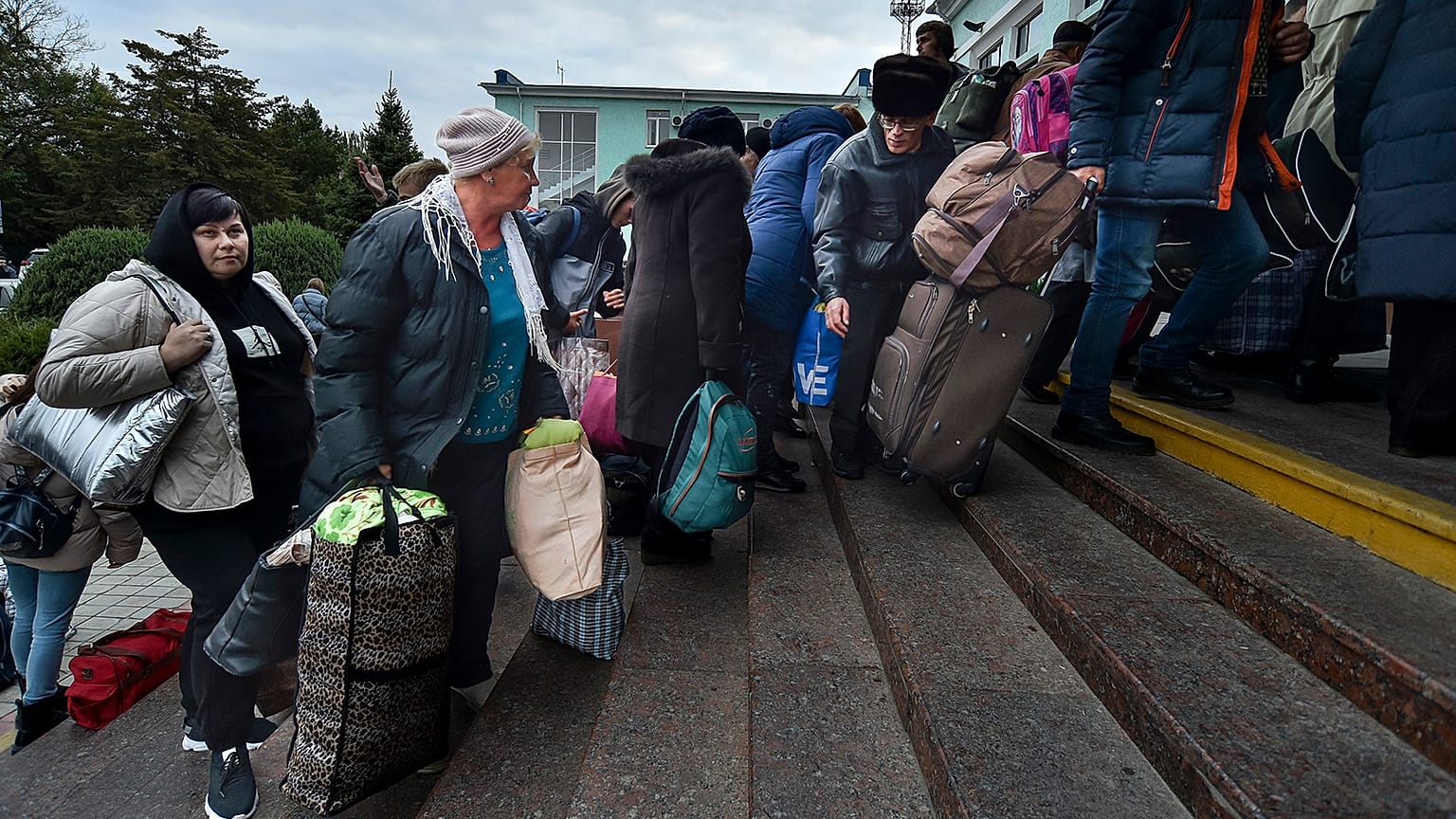 Departees from Kherson gather upon their arrival at the railway station in Dzhankoi, Crimea, 21 October 2022
