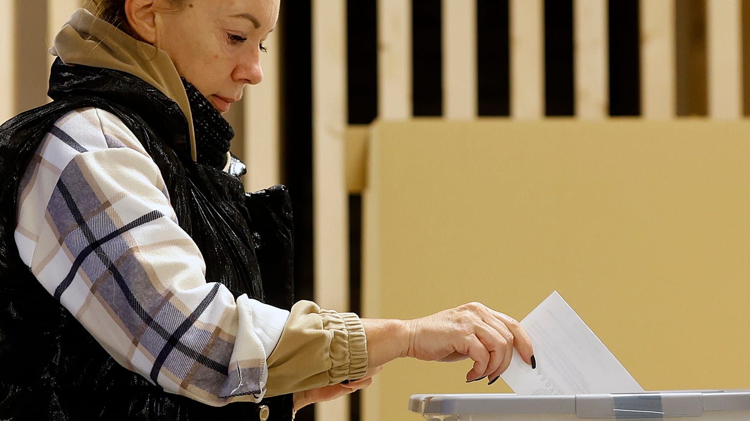 A woman casts her ballot for a presidential election at a poling station in Ljubljana, 23 October 2022