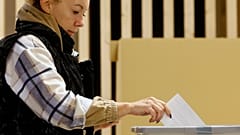 A woman casts her ballot for a presidential election at a poling station in Ljubljana, 23 October 2022