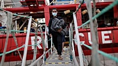 Migrants disembark in the port of Taranto, southern Italy.