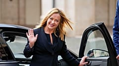 Italian Premier Giorgia Meloni waves to cameras as she leaves after swearing in at Quirinal presidential palace, Saturday, Oct. 22, 2022.