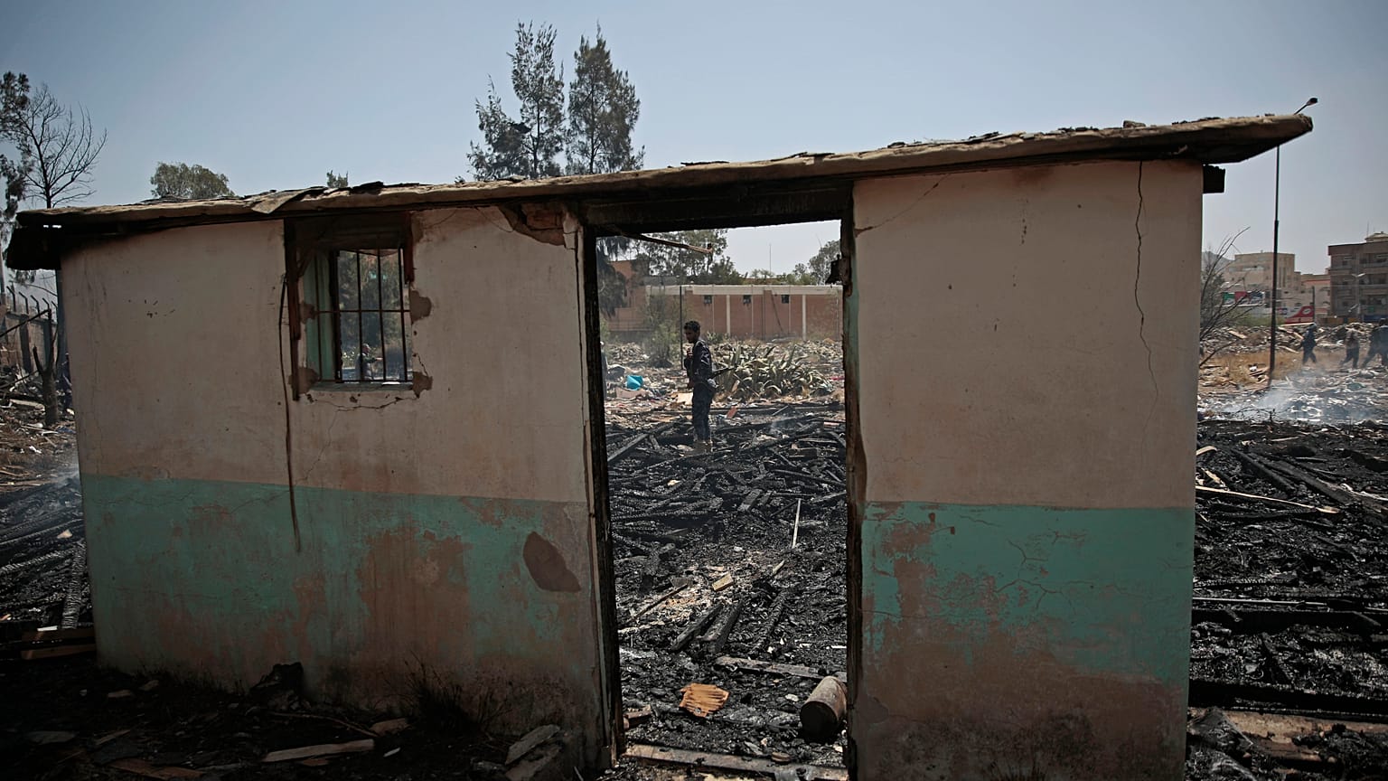 A Yemeni soldier inspects a site of Saudi-led airstrikes targeting two houses in Sanaa.
