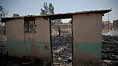 A Yemeni soldier inspects a site of Saudi-led airstrikes targeting two houses in Sanaa.