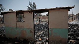 A Yemeni soldier inspects a site of Saudi-led airstrikes targeting two houses in Sanaa.