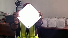 Dozie Igweilo holds a QuadLoop solar lamp