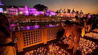 People light lamps on the banks of the river Saryu in Ayodhya, India 