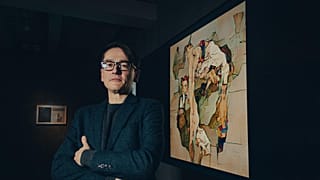 Mario Klingemann stands in front of Assymetrical Liberation by Botto