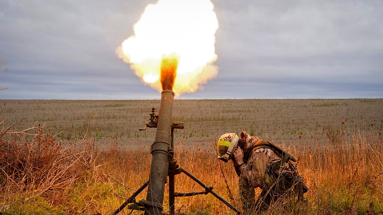 Ukrainian National guard soldiers fire at Russian positions with a mortar near Kharkiv, Ukraine, Tuesday, Oct. 25, 2022.