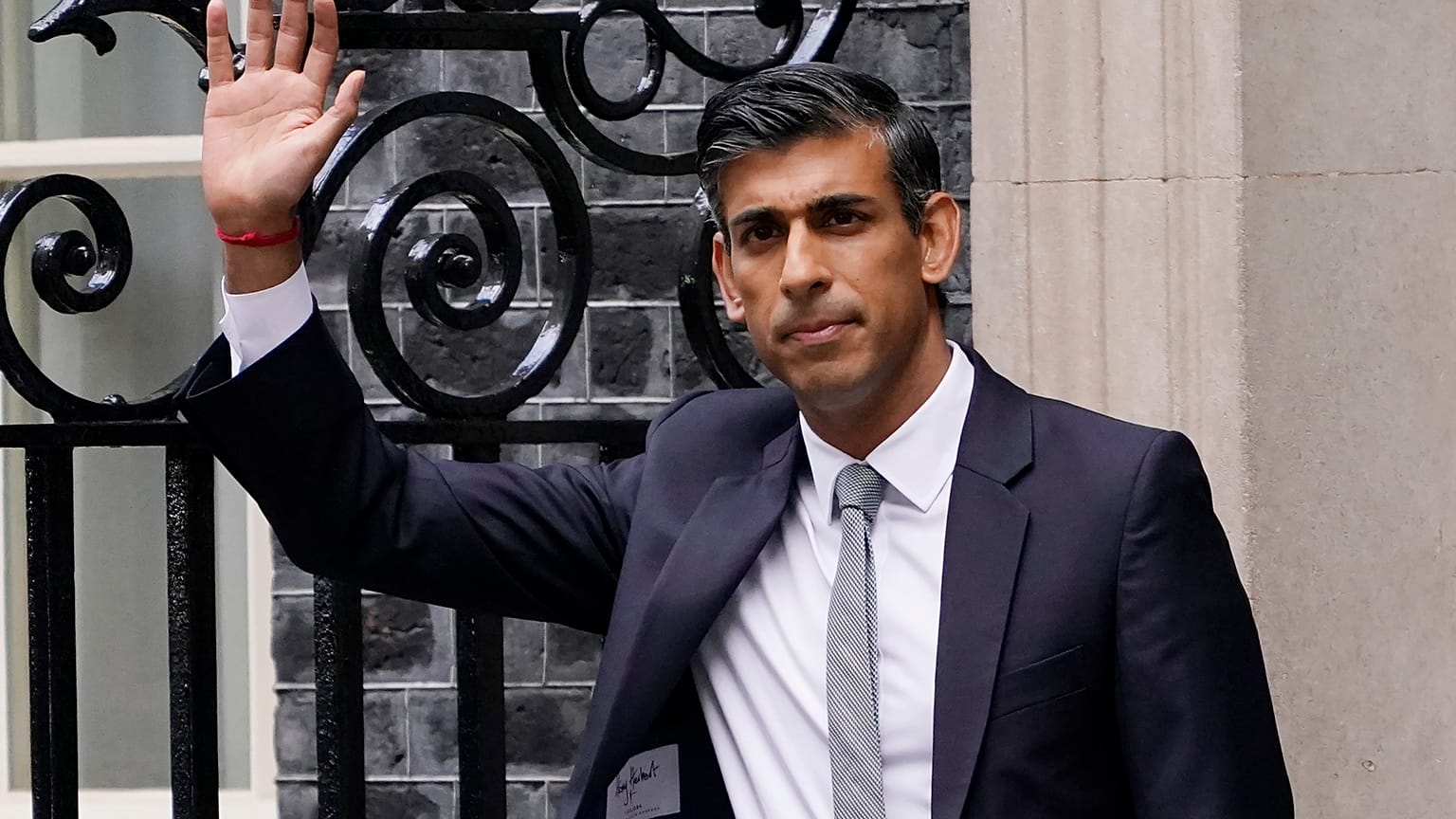 New British Prime Minister Rishi Sunak waves after arriving at Downing Street in London