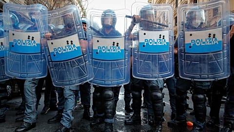 Police officers face demonstrators protesting on the sidelines of a G20 environment meeting, in Naples, Italy. Thursday 22 July 2021.